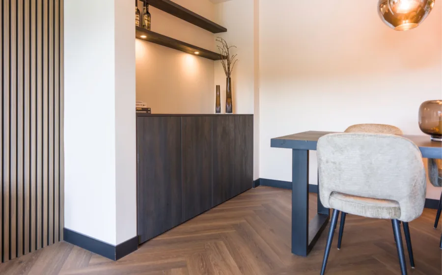 hotel chic woonkamer, bruine houten wandpanelen en zwarte kast op maat