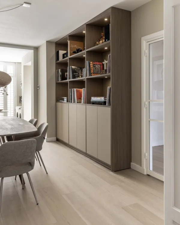 Eetkamer met prachtige houtlook vloer en kast op maat met verlichting voor extra sfeer en opbergruimte.