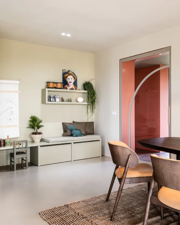 Woonkamer met lichtgrijze betonlook vloer en retro meubelen