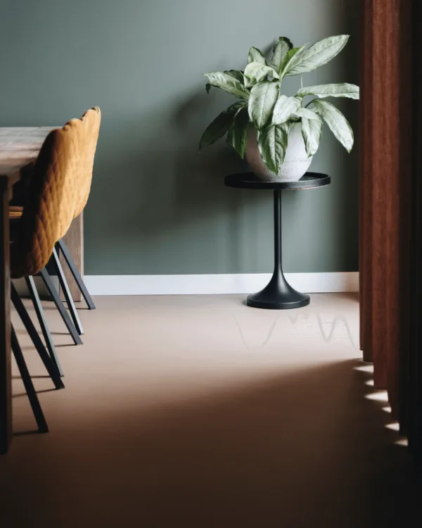 Sfeerfoto grijze gietvloer bij eettafel met gordijnen