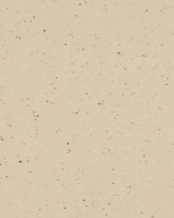 Crèmekleurig marmoleum met een subtiel gespikkelde structuur.