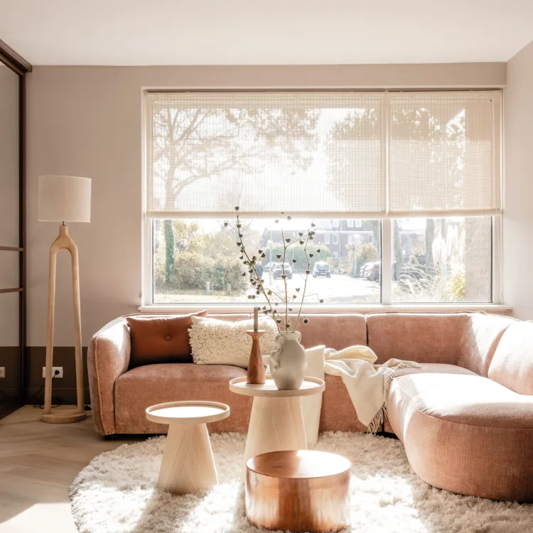 Lichte woonkamer met roze tinten en bamboe rolgordijnen