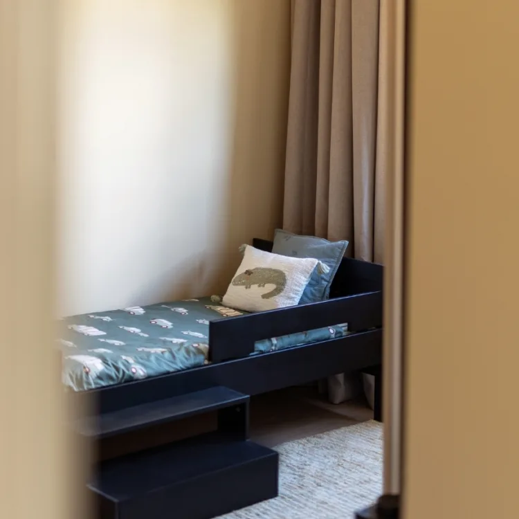 Sfeerfoto kinderkamer neutrale tinten met bruin beige overgordijnen