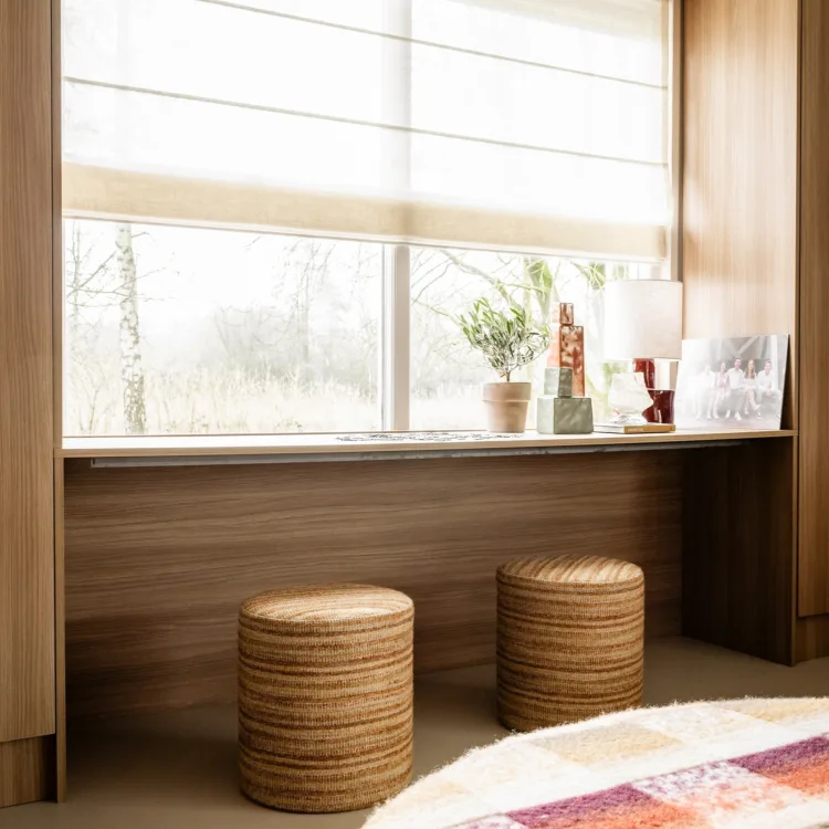 Open leefruimte met harmonieuze mix van Scandinavisch en werelds interieur Raamdecoratie met vouwgordijnen die zorgen voor zacht licht en een warme uitstraling.